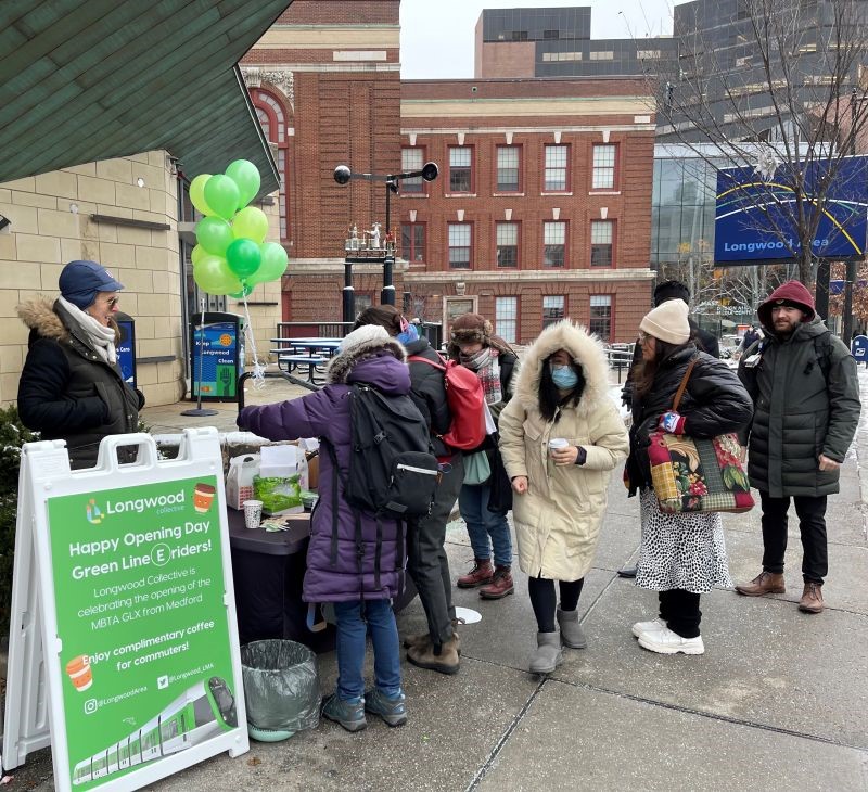 Commuters having coffee with Longwood Collective staff at LMA stop on E Line