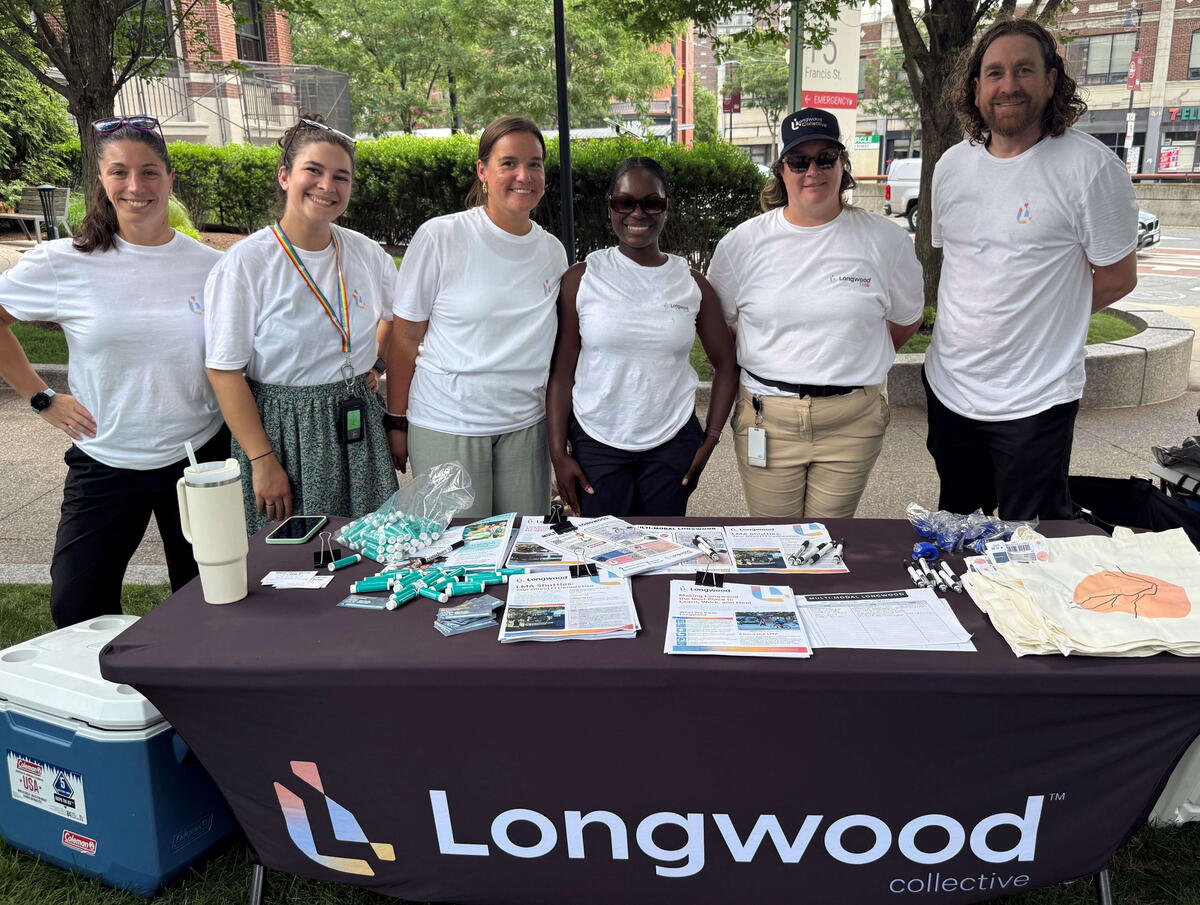 Staff members pose at the TMA Meet Your Mode table