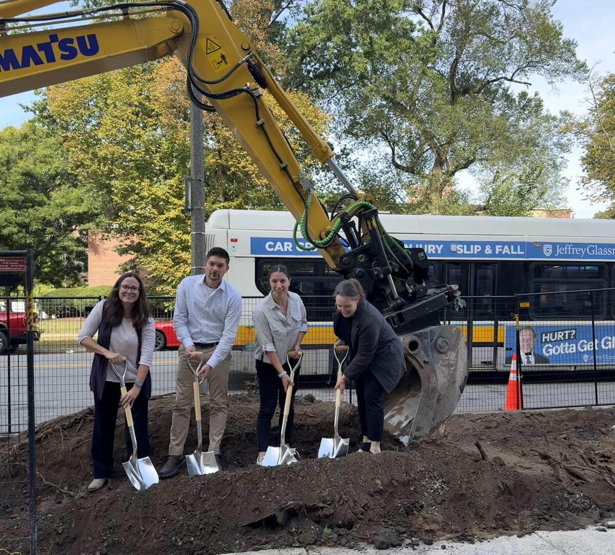 four people dig shovel into the ground