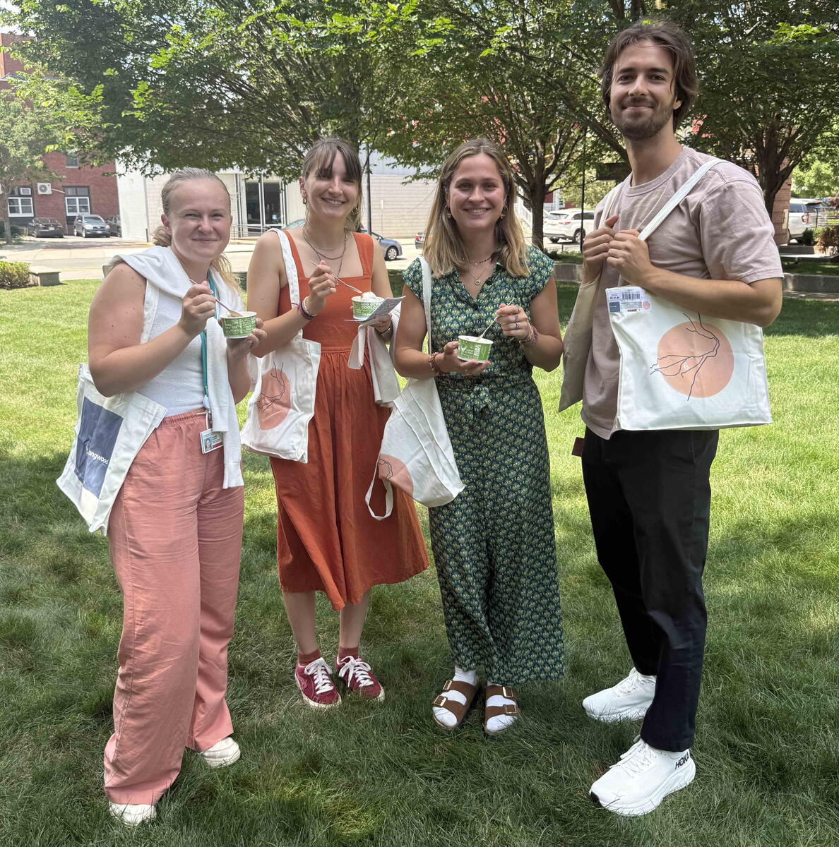 researchers smile with free ben and jerry's