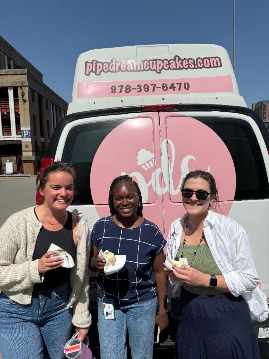 people pose in front of cupcake truck