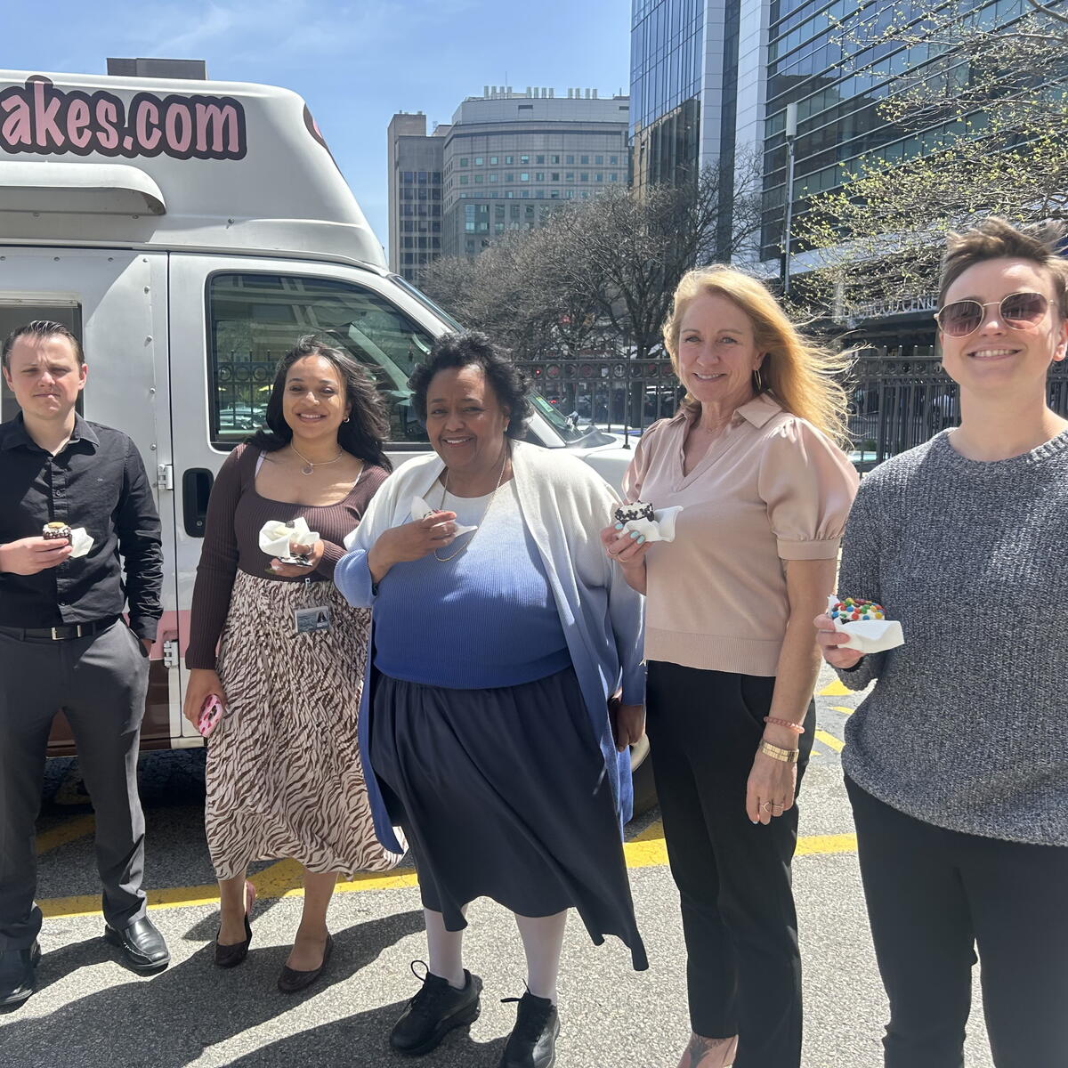 people pose with cupcakes